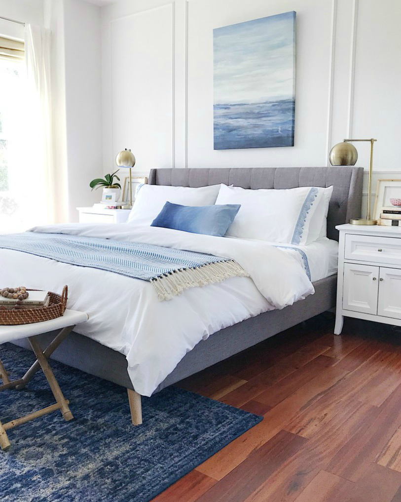 Calming blue and white master bedroom with coastal artwork and Serena & Lily bedding - jane at home #bedroomdecor #bedroomideas #bedroomdesign