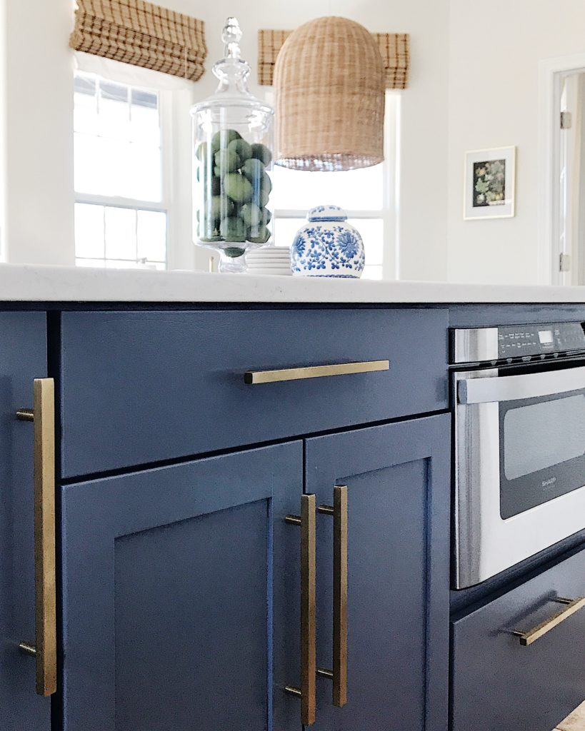 Here's where we are with our kitchen renovation - white kitchen with blue island, gold accents and subway tile
