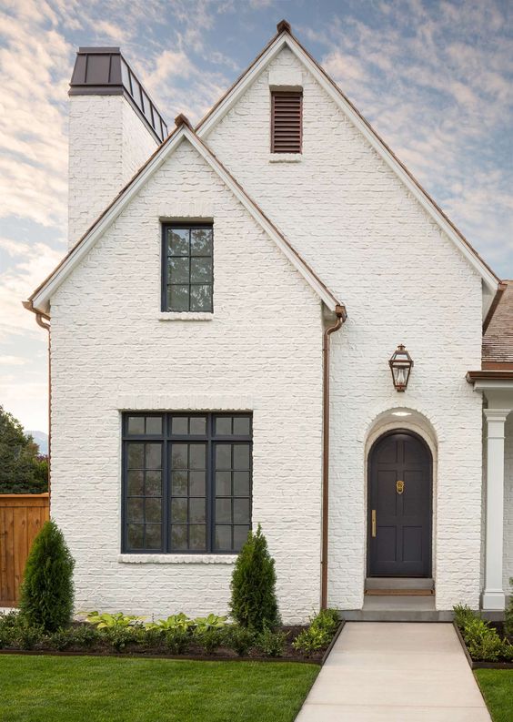 Beautiful home exterior with white painted brick and black front door - my favorite pins of the week