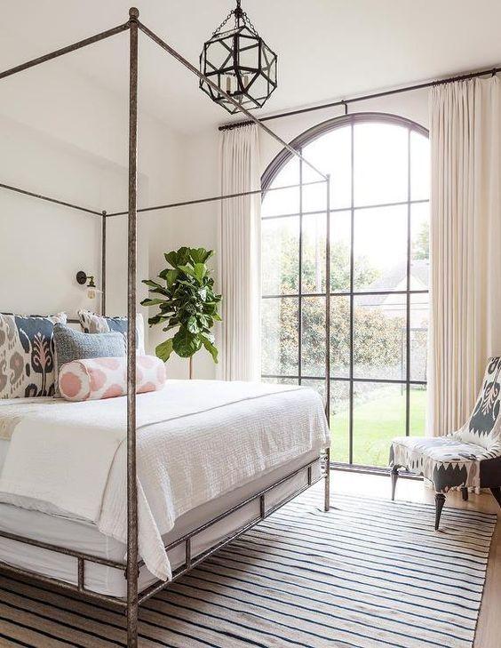 Large, arched window + simple pretty bed with poster - Theresa Rowe #bedroomideas #bedroominspo #bedroomdecor