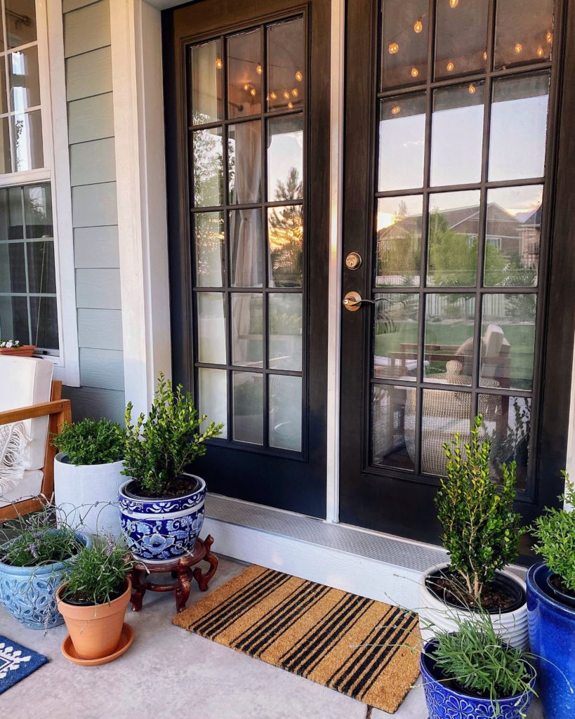 Summer home decor essentials on the patio - striped welcome mat, black French doors - jane at home 