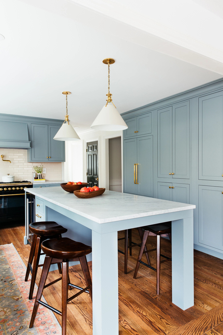Beautiful kitchen with light blue cabinets and open seating in island