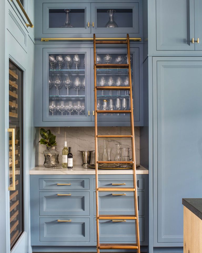Love this gorgeous kitchen design with floor to ceiling blue kitchen cabinets and a library ladder - caren rideau