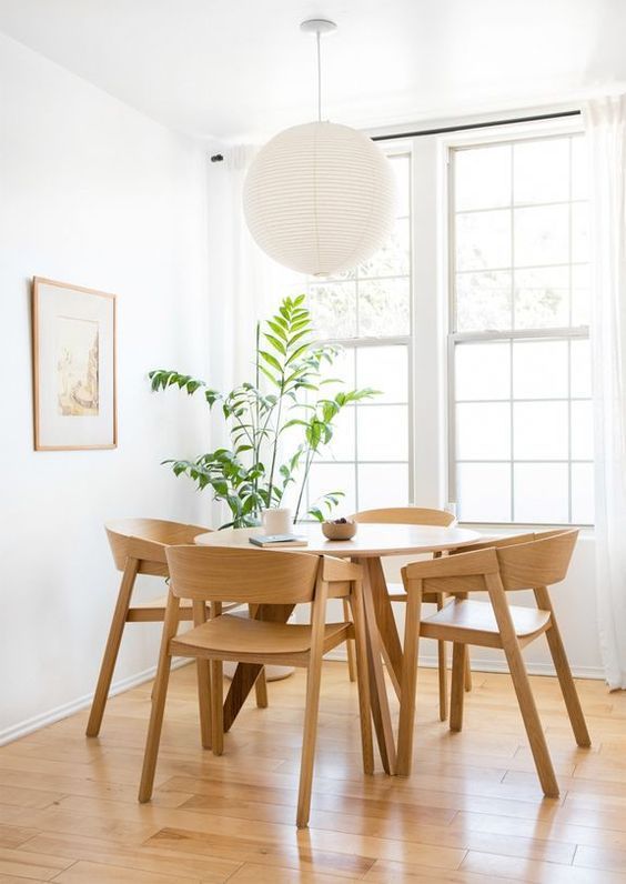 Love this beautiful breakfast nook with a round wood dining table, wood dining chairs, and a paper lantern pendant light - dining room ideas - kitchen dining ideas - dining room furniture - dining nook ideas - dining room lighting ideas