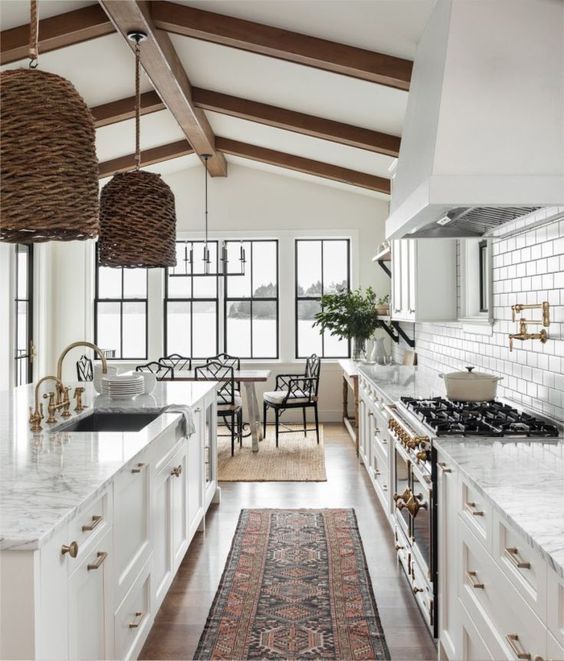 Beautiful white kitchen design with woven pendants and vintage runner | Marianne Simon