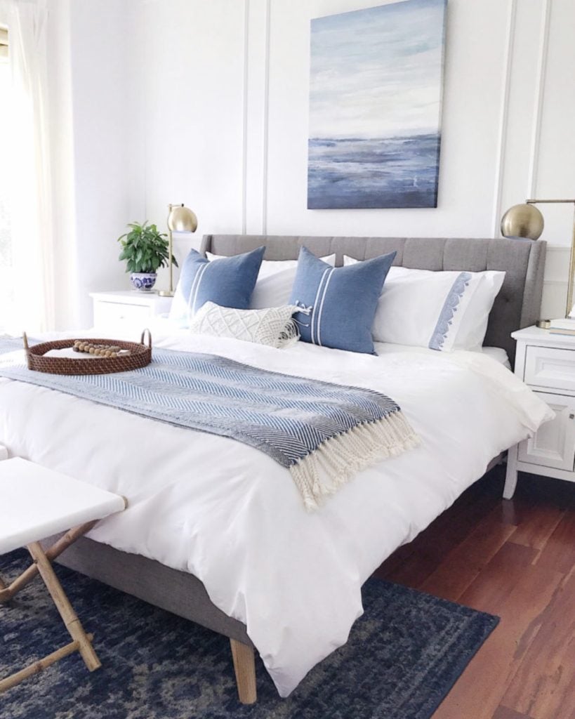 Calming blue and white coastal inspired master bedroom design