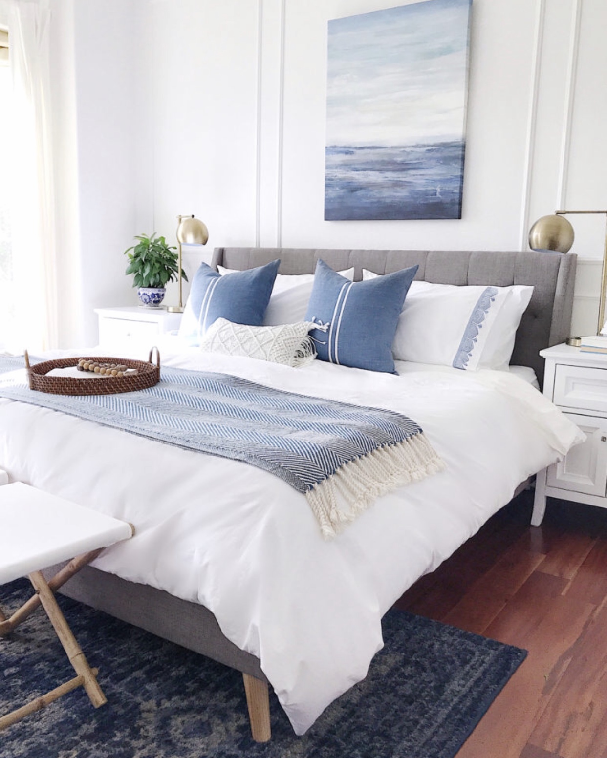 Calming blue and white coastal inspired master bedroom design - jane at home