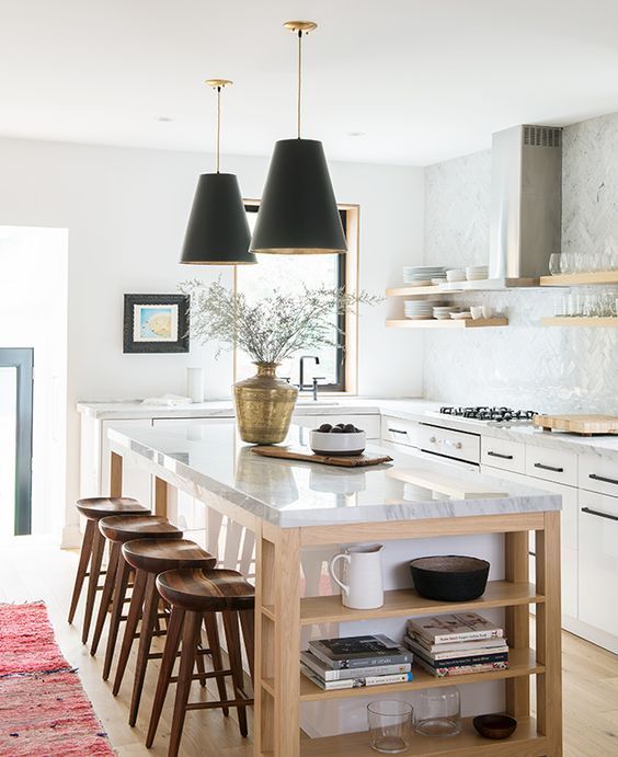 Beautiful light wood and white kitchen with black pendant lights over island and red Turkish runner