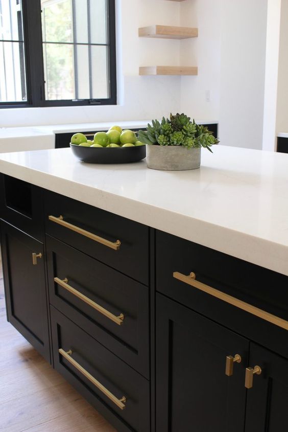 Love this beautiful kitchen design with a dark island color, brass cabinet pulls, and white countertops - house of silver lining
