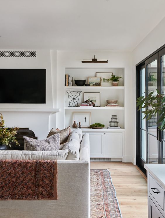 Beautiful modern living room design with built in shelving and neutral tones - Amber Interiors