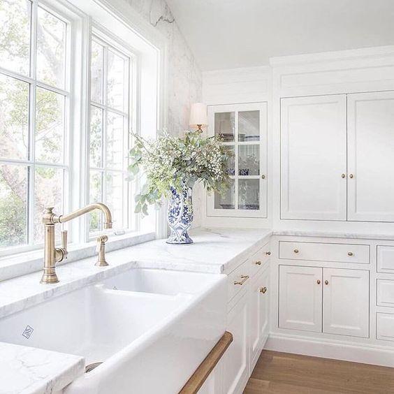 Love this beautiful timeless kitchen design with white cabinets, brass hardware, light oak wood flooring, and a drip rail under the sink - kitchen remodel - white kitchen cabinets - the fox group