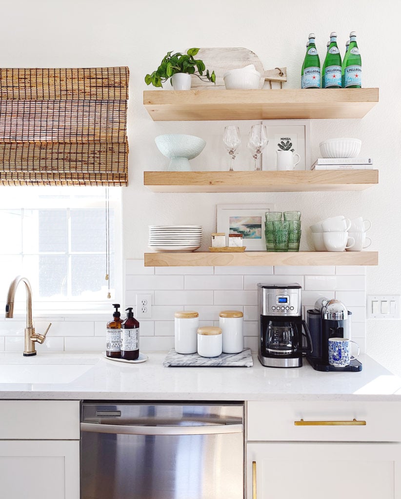 Open shelving in the kitchen with white and blue decor and gold faucet and cabinet hardware - jane at home #kitchendecor #kitchenideas #kitchendesign #home #style #decor