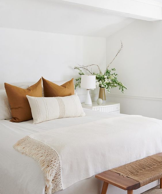 Love this beautiful bedroom design with white bedding, a woven bench, and neutral pillows, furniture, and decor - bedroom ideas - guest bedroom - master bedroom - small bedroom - boho bedroom - jenni kayne