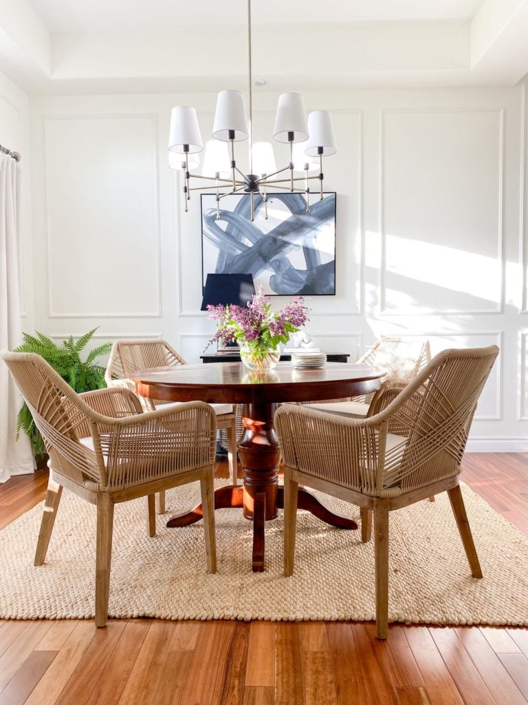 Dining room with woven chairs and jute rug - jane at home