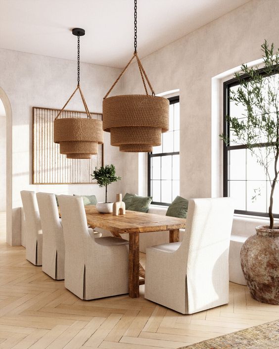 Neutral dining room idea - woven tiered pendant lights and slipcovered dining chairs