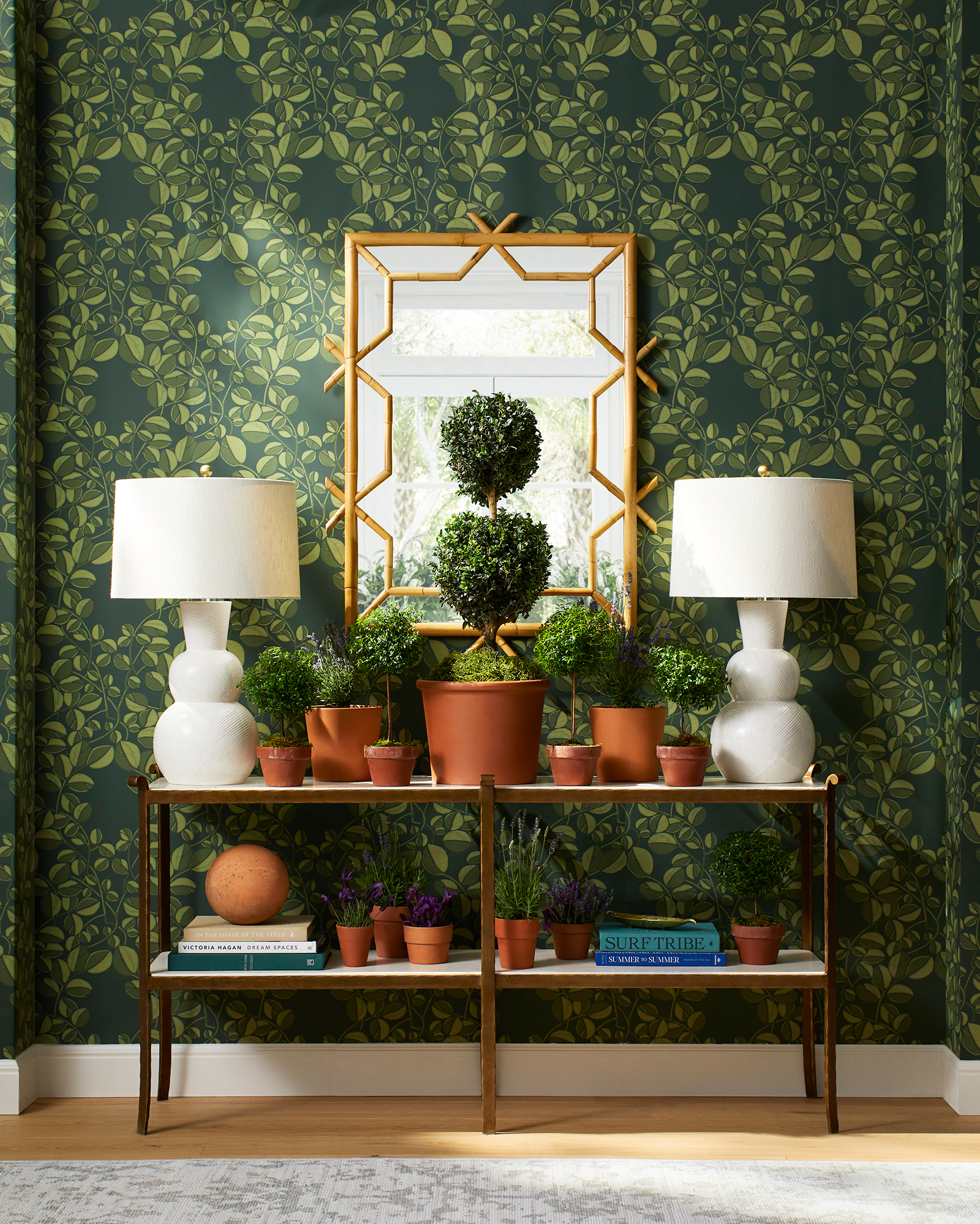 Love this beautiful sage green wallpaper for fall, along with the console table, lamps and potted topiaries create a beautiful fall scene #falldecor #wallpaperideas #floralwallpaper #serenaandlily