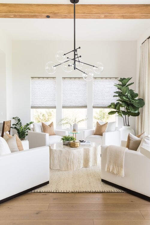 Love this modern living room with four white chairs around a central coffee table and unique modern pendant light - pure salt interior design #livingroom #coastallivingroom #moderncoastal #coastalstyle #livingroomdecor #livingroomideas #keepingroom