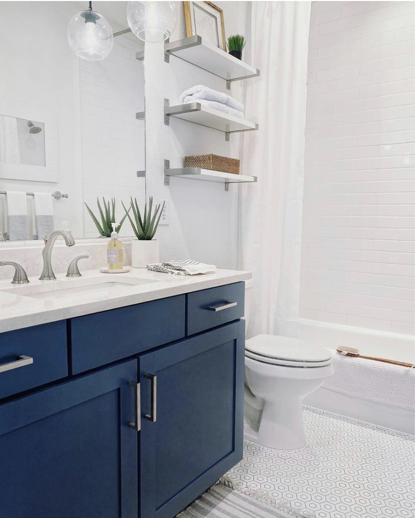 How I added a touch of modern coastal style to our guest bathroom - bathroom decor - bathroom remodel - small bathroom ideas - blue vanity - Benjamin Moore Van Deusen Blue