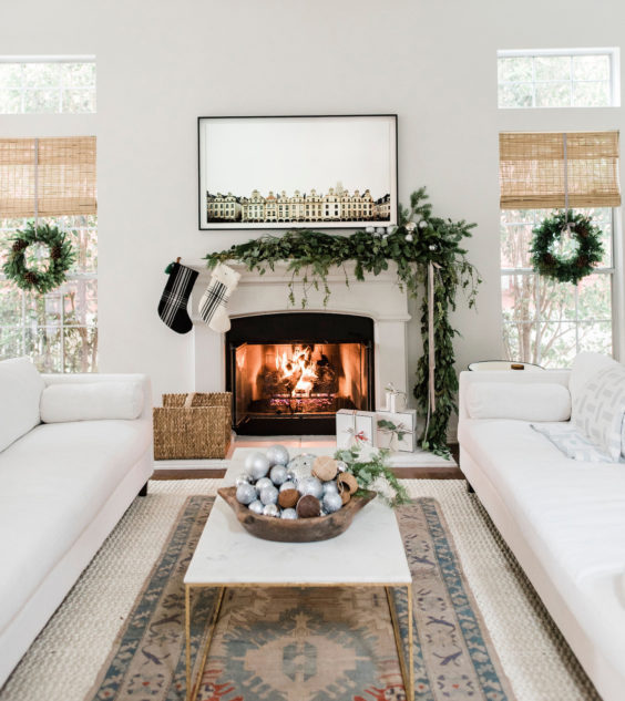 Modern Christmas decor in the living room with draped garland over mantel - identite collective