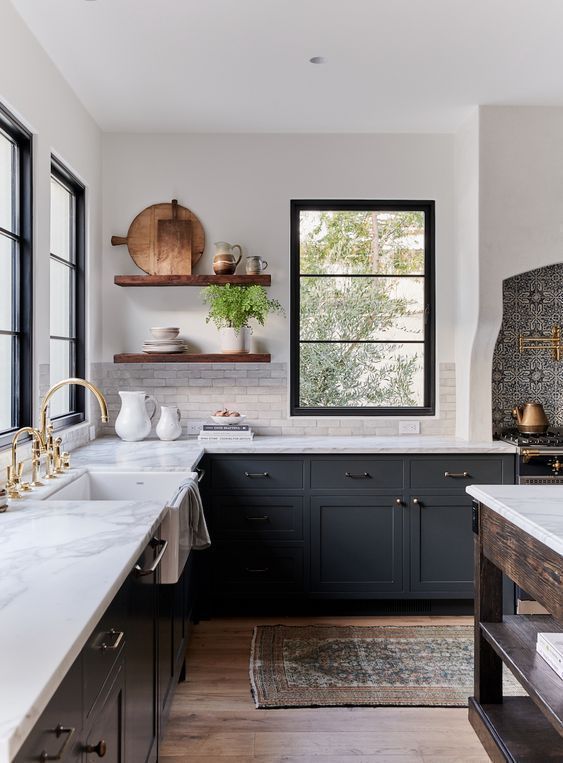Beautiful two-toned kitchen with dark gray cabinets and open shelving | Amber Interiors