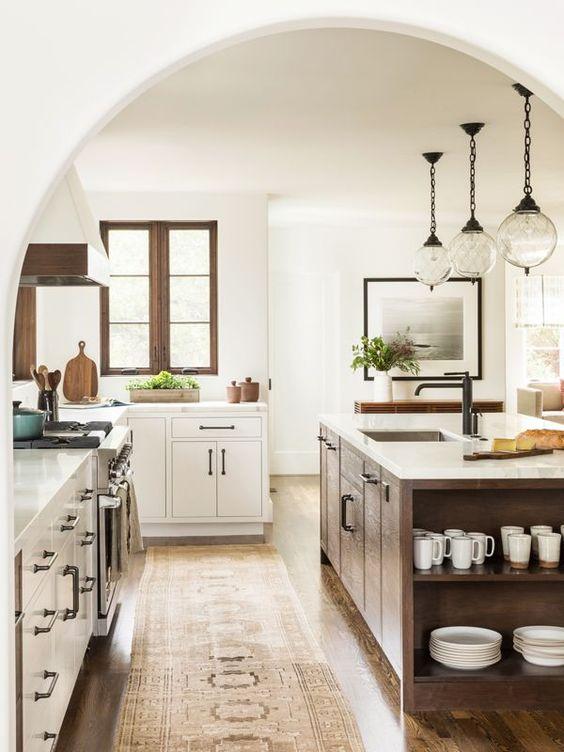 Love this beautiful kitchen design with white cabinets and a dark wood kitchen island - jute home