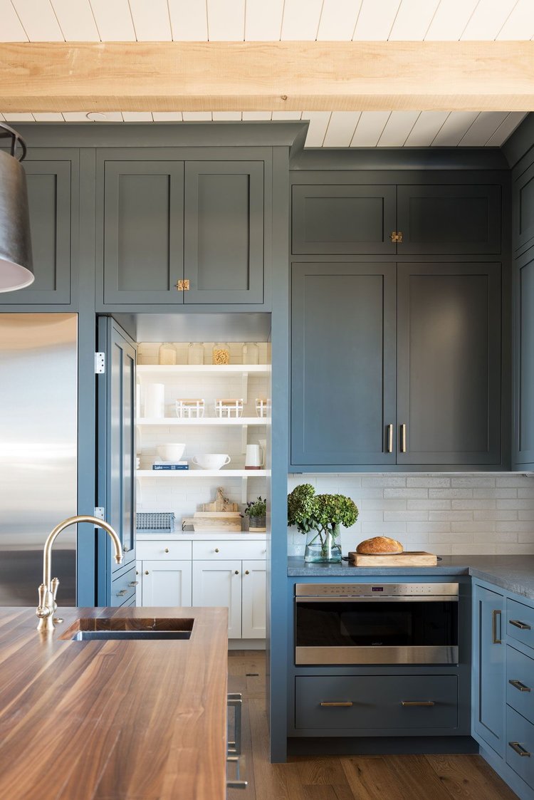 I love how they incorporated a hidden pantry the kitchen via a door that looks like cabinetry. 