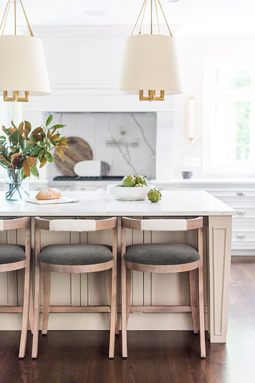Love this beautiful timeless kitchen design with a light oak wood kitchen island, white kitchen cabinets, and white and brass pendant lights - transitional style - transitional kitchen - whittney parkinson design