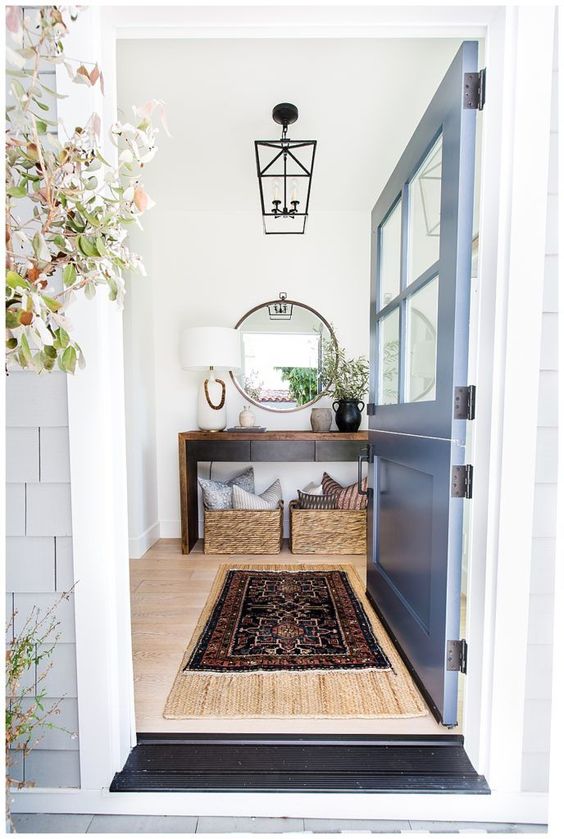Entryway with blue Dutch door and rustic wood console table