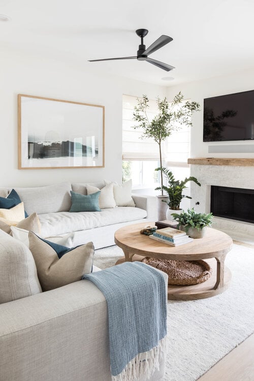 A contemporary living room with beautiful center table styling and warm coastal style