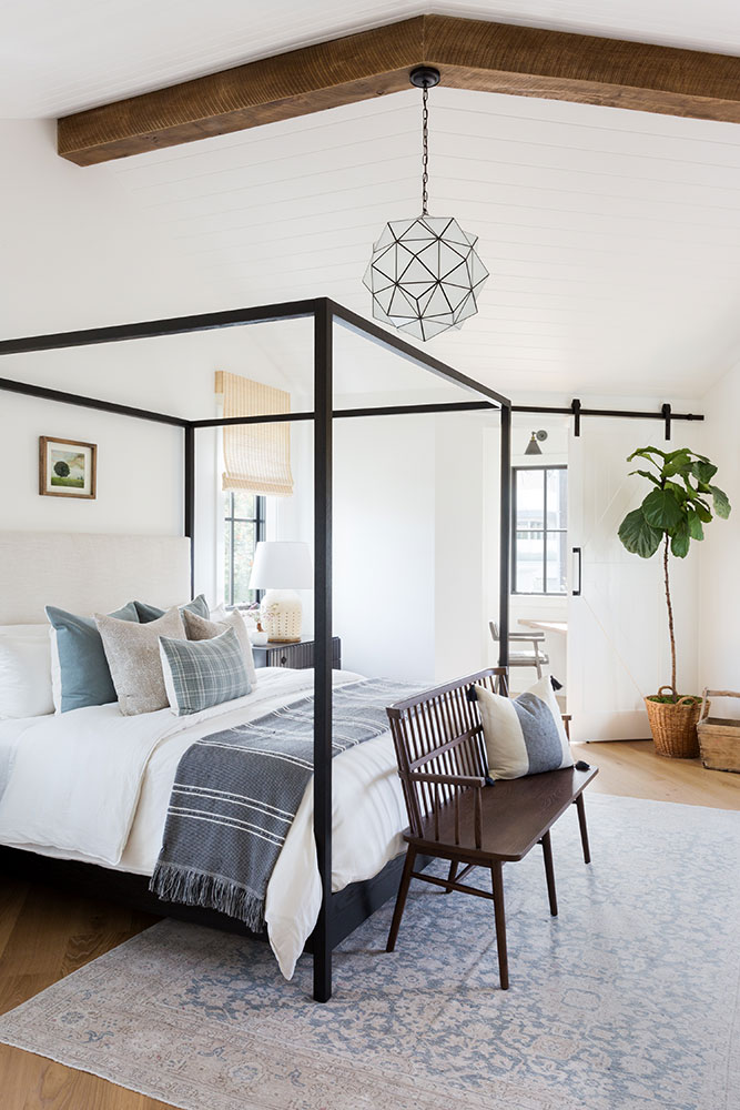 Such a gorgeous master bedroom! I love the shiplap on the ceiling, as well as the wood beams, amazing light fixture, canopy bed, and gorgeous touches of blue against all the white!  All so beautiful! bedroom ideas - bedroom decor - master bedroom - guest bedroom - guest room - bedroom design
