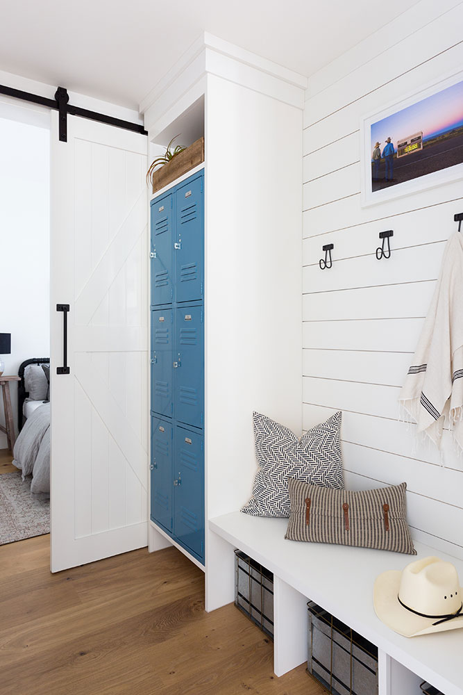 Love this beautiful and functional mudroom design with shiplap walls and blue lockers for storage - kate lester interiors