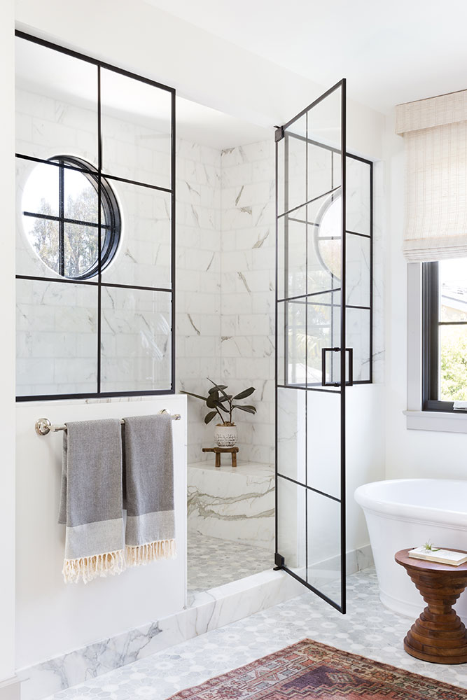 I'm crazy about this beautiful bathroom design!  The amazing shower enclosure, marble seating in the shower, beautiful tile combination, and wonderful round window all work together to create such a stunning space! bathroom decor - bathroom ideas - bathroom design - master bathroom - bathroom remodel