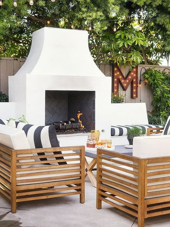 Love this beautiful outdoor living area with beautiful wood seating and fireplace - patio ideas - patio decor - outdoor seating - teresa hlista