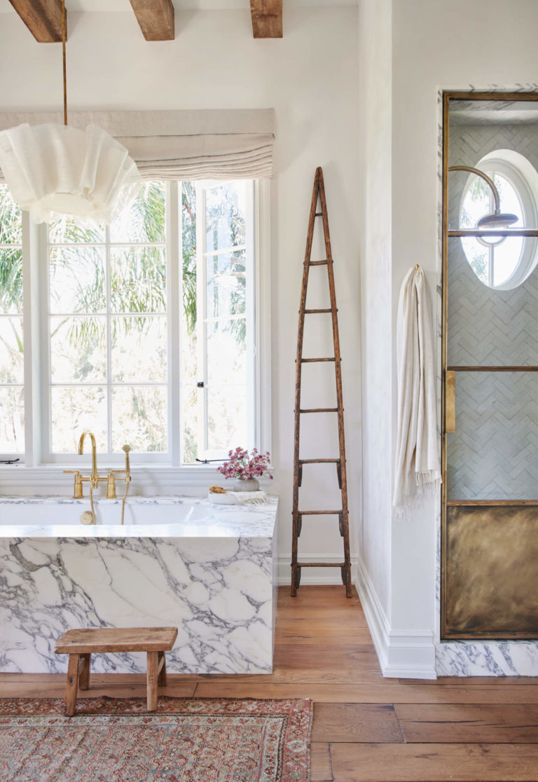 This stopped me in my tracks! Such a beautiful bathroom idea! I love everything about this design -- the square marble tub, the wood beams, the vintage rug, stool, and ladder--and that amazing light fixture! Such a gorgeous space from Amber Interior Design! bath - bathroom ideas - bathroom design - bathroom decor - bathroom remodeltadt