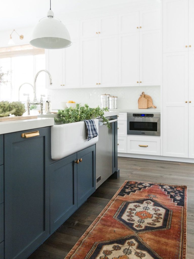 I love this beautiful modern kitchen, with its rich blue island, colorful vintage rug and white cabinets! kitchen remodel - kitchen ideas - blue kitchens - white kitchen - kitchen design = kitchen decor - modern kitchen