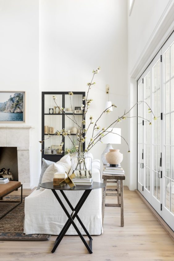 This beautiful light and airy living room has such a fresh, spring feeling! I love the white slipcovered sofa and the beautiful styling on the side table and console table, as well as the beautiful black cabinet! Such a dreamy space! living room ideas - living room design - living room decor - living room furniture