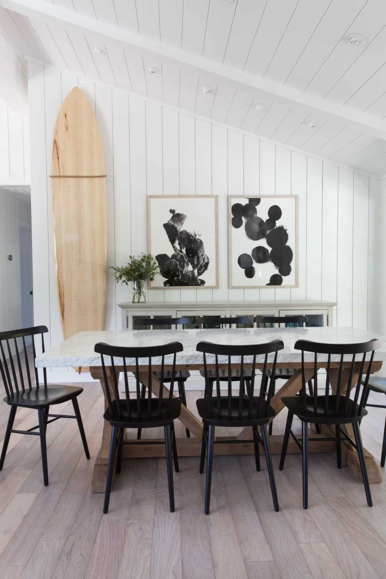 This neutral dining room is layered, sophisticated, and welcoming! I love the addition of the light wood surfboard and crisp shiplap walls! Mixing wood tones and black is a great way to add interest when the color palette is neutral. 