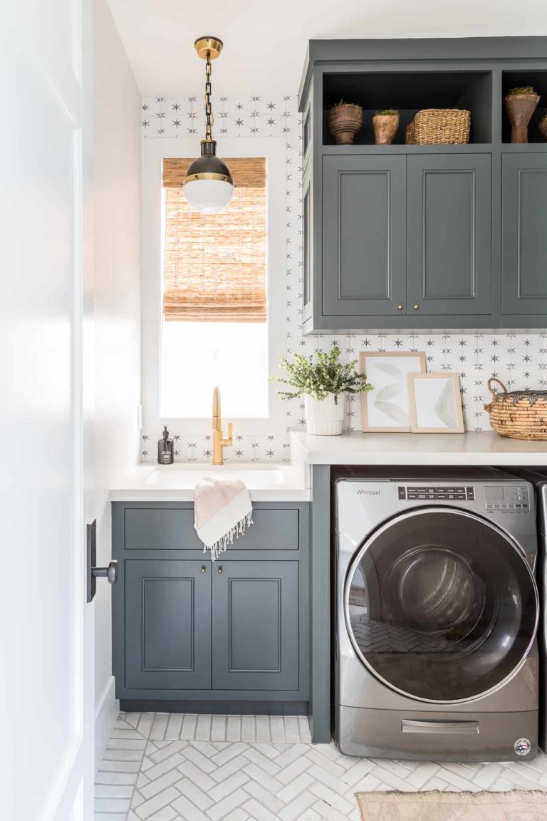 Such a beautiful laundry room! I love the cabinet color -- as well as the idea of adding open storage on top! The herringbone tile floors are amazing -- and I love that wallpaper! laundry room ideas - laundry room decor - laundry room design