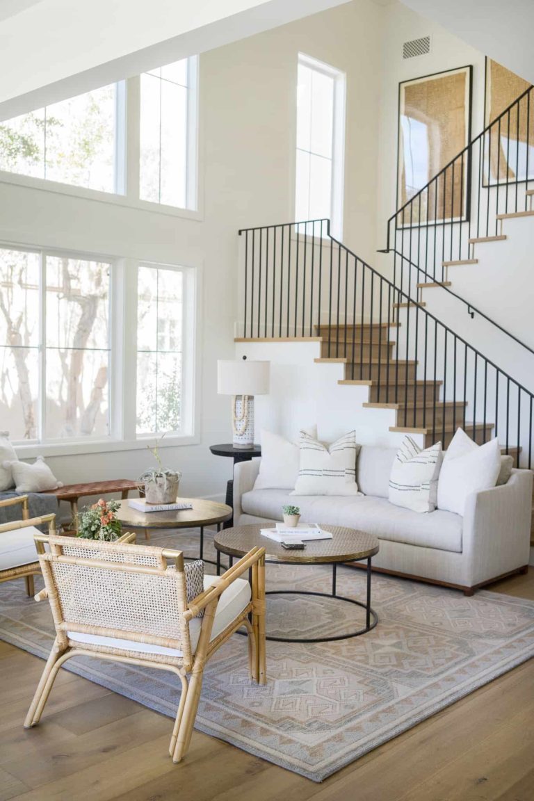 Love this beautiful living room design showing how to arrange furniture with an open layout including a staircase - living room ideas - living room layout - living room furniture - stairway - stair ideas - mindy gayer