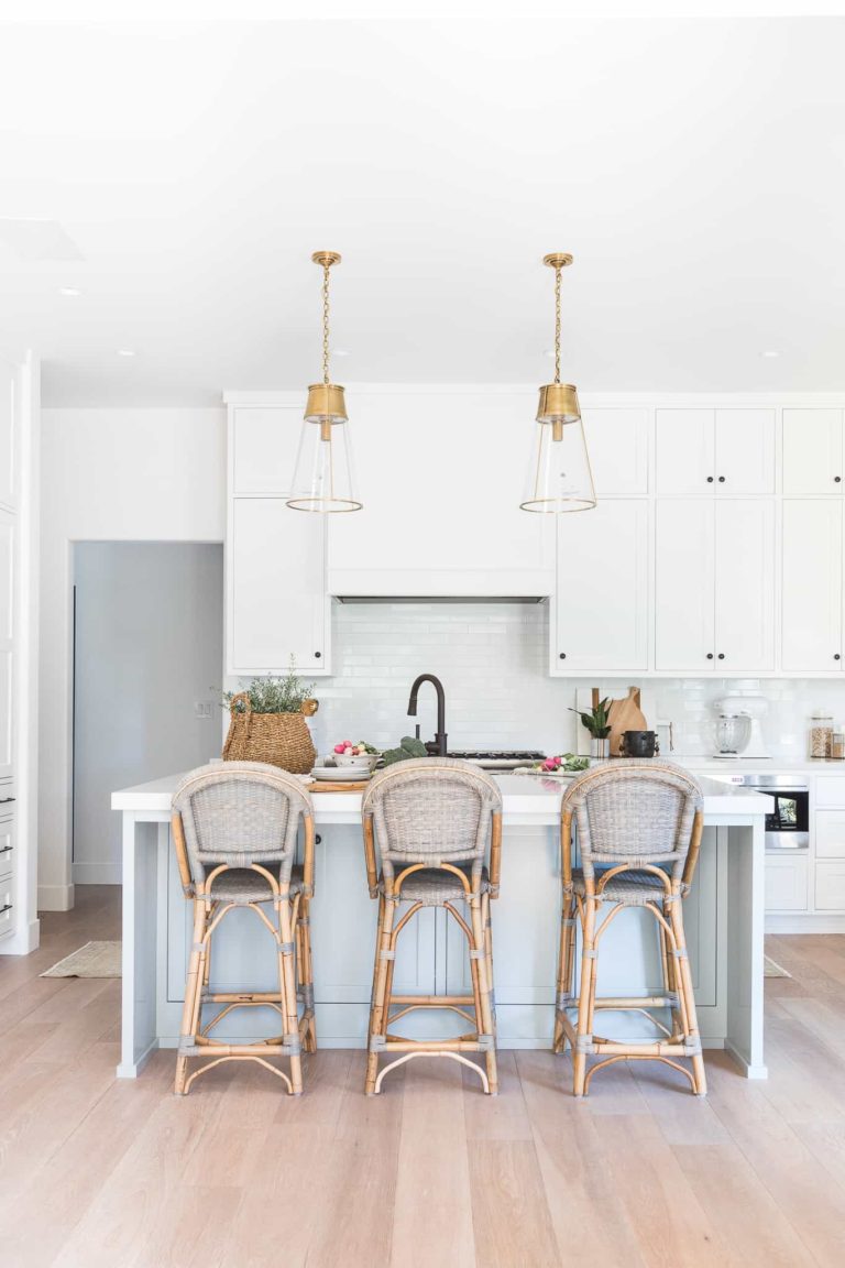 Gorgeous modern coastal kitchen with bistro counter stools and brass and glass cone pendant lights over the island - white kitchen - modern coastal kitchen - kitchen remodel - kitchen ideas - kitchen lighting - kitchen furniture