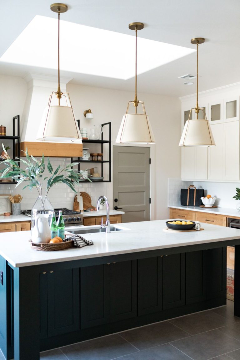 Love the mix of the blue island with wood cabinets in this beautiful kitchen - aren't those light fixtures perfect in this space?