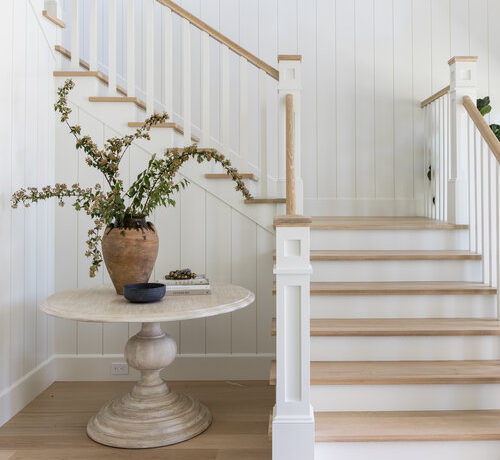 Love this beautiful entryway and staircase idea with a round wood table and white and wood stairs - entry ideas - foyer - entryway ideas - stairway ideas