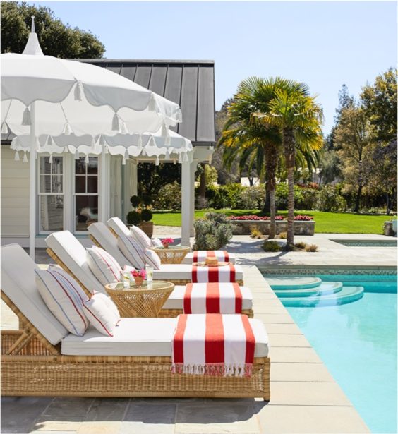 Beautiful outdoor patio area with chaise lounge chairs and umbrellas - Serena & Lily