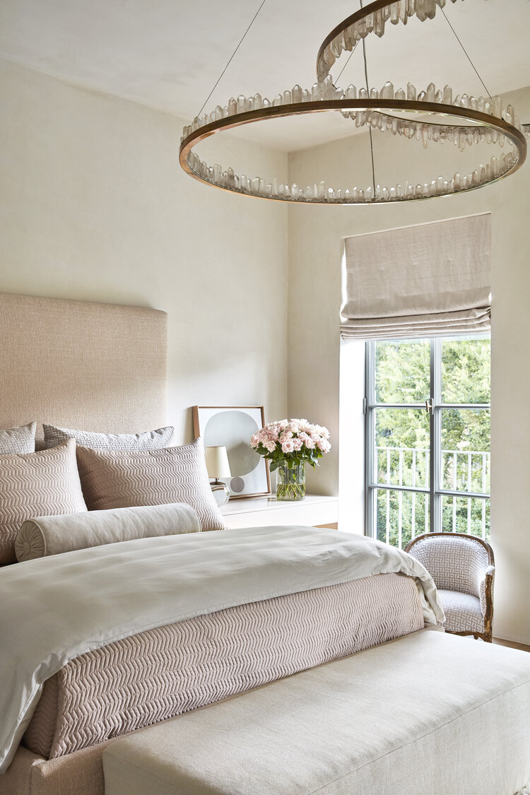 Gorgeous feminine master bedroom with soft blush tones and stunning chandelier - Jill Egan 