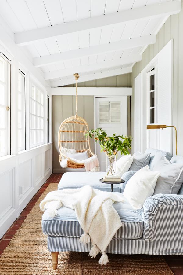 Love this gorgeous sunroom with its hanging swing chair and double chaise lounges
