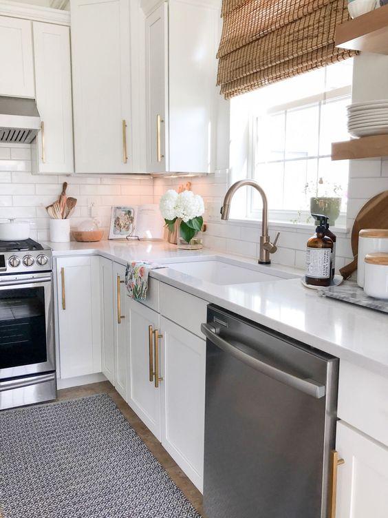 Our kitchen features a mix of white cabinets, brass hardware and fixtures, open shelving, and a touch of modern coastal style - Jane at home - coastal grandmother aesthetic - coastal decor - coastal cottage kitchen - coastal grandma style