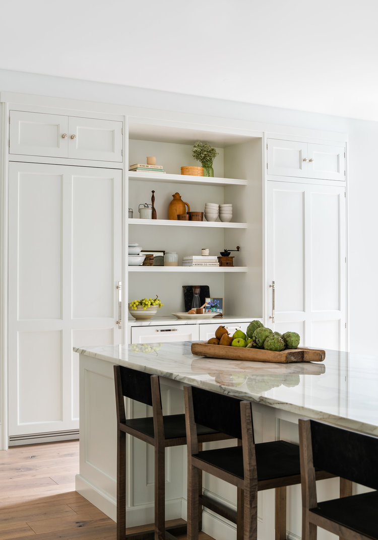 A beautiful classic kitchen design with white cabinets and marble countertops - thea home