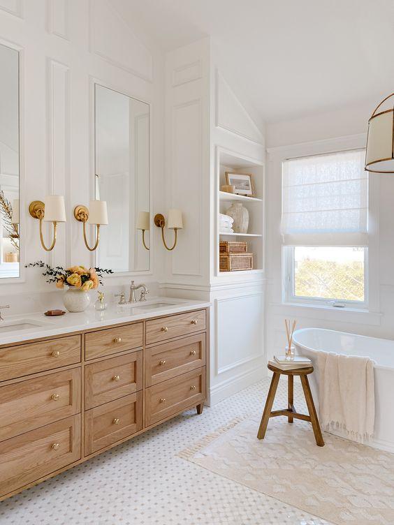 Love this beautiful master bathroom with a light oak wood vanity, brass metal finishes, and neutral decor and lighting - akb design studio