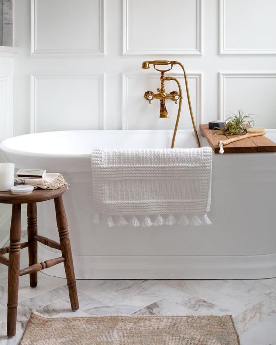 Beautiful all white bathroom design with marble tile floor, freestanding tub and accent wall trim - bathroom remodel - bathroom ideas - bathroom design