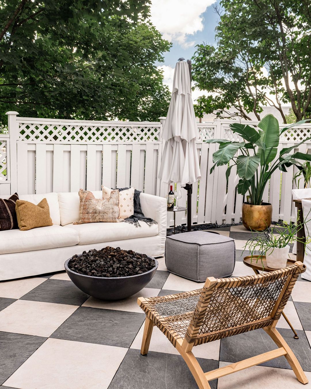 Beautiful outdoor seating area and living space with checkerboard tile flooring and sofa - patio ideas 